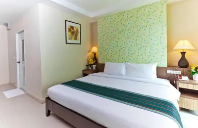 a bedroom with a large bed in a hotel room at Sunday Platinum Suites in Bangkok