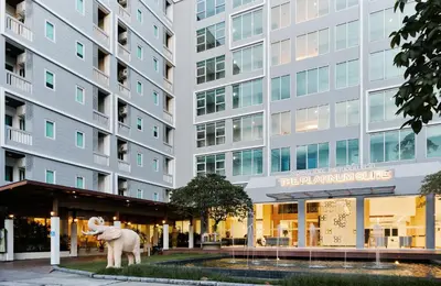 a statue of a horse in front of a building at Sunday Platinum Suites in Bangkok