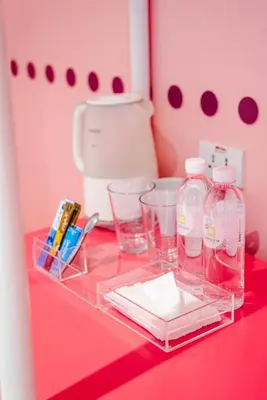a red counter with bottles and glasses on it at Budacco The Living Place in Bangkok