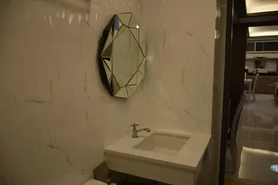 a bathroom with a sink and a mirror on the wall at Family Suite Room Pratunam in Bangkok