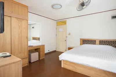 a bedroom with a bed and a sink and a mirror at The Aiyapura Bangkok in Bangkok