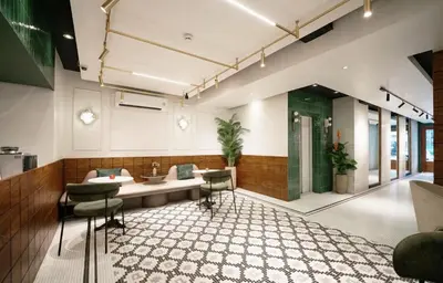 a waiting room with a sink and chairs at Grand Inn Hotel in Bangkok