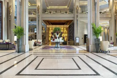 a lobby with a fountain in the middle of a building at Siam Kempinski Hotel Bangkok in Bangkok