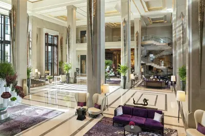 a lobby with a purple couch in a building at Siam Kempinski Hotel Bangkok in Bangkok