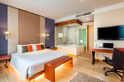 a bedroom with a bed and a desk and a television at Hotel Solo, Sukhumvit 2, Bangkok - SHA Extra Plus in Bangkok