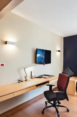 a desk with a computer and a chair in a room at Hotel Solo, Sukhumvit 2, Bangkok - SHA Extra Plus in Bangkok