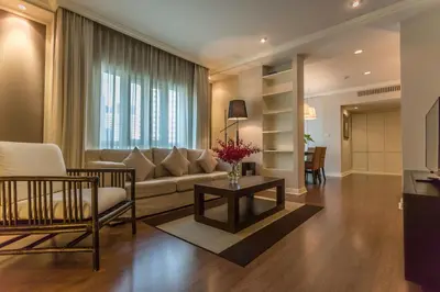a living room with a couch and a table at At 21 Saladaeng in Bangkok