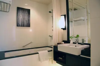 a bathroom with a sink and a bathtub and a sink at At 21 Saladaeng in Bangkok