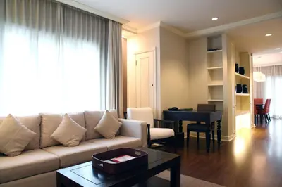 a living room with a couch and a table at At 21 Saladaeng in Bangkok
