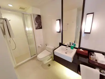 a bathroom with a toilet and a sink and a shower at At 21 Saladaeng in Bangkok