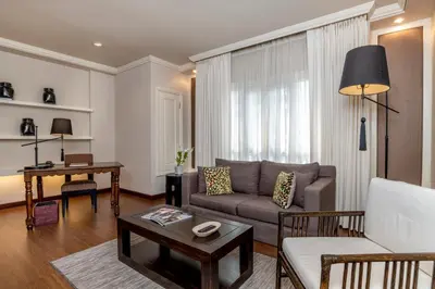 a living room with a couch and a table at At 21 Saladaeng in Bangkok