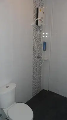 a bathroom with a toilet and a shower at Little Home in Nonthaburi