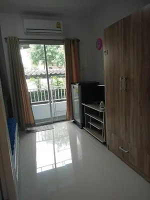 a room with a kitchen with a large window at Little Home in Nonthaburi