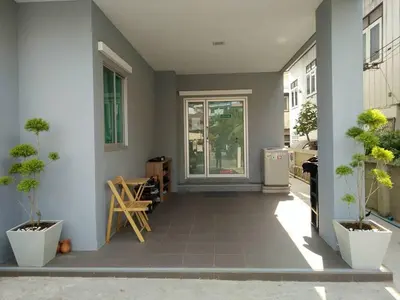 a hallway with potted plants and a entry way at Little Home in Nonthaburi
