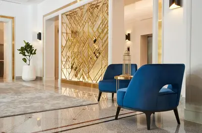 a lobby with two blue chairs and a table at Bliston Suwan Park View in Bangkok