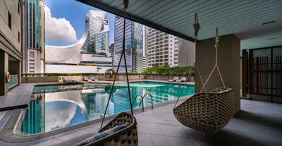 a swimming pool with swings on a building at Bliston Suwan Park View in Bangkok