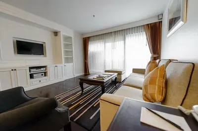 a living room with a couch and a tv at Bliston Suwan Park View in Bangkok
