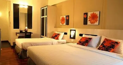 a hotel room with two beds in a room at The Inn Saladaeng in Bangkok