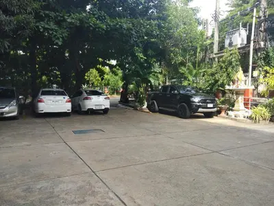 a group of cars parked in a parking lot at Nontharat Mansion in Nonthaburi