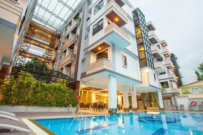 a building with a swimming pool in front of a building at New Siam Palace Ville Hotel in Bangkok