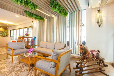 a living room with a table and a horse statue at New Siam Palace Ville Hotel in Bangkok