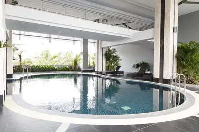 a swimming pool in the middle of a building at Green Point Residence Hotel in Bangkok