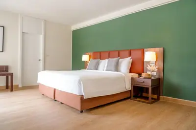 a large bedroom with a large bed and two lamps at The Legacy Hotel Nana Sukhumvit, Aspira Collection in Bangkok