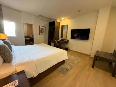 a bedroom with a large bed and a television at The Legacy Hotel Nana Sukhumvit, Aspira Collection in Bangkok