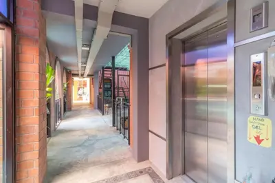 an alleyway in a building with a door open at Baansuanprannok Hotel in Bangkok