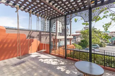 a balcony with a table and a view of a street at Baansuanprannok Hotel in Bangkok