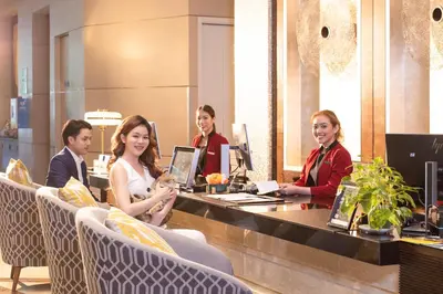a group of people sitting at a table with computers at Sathorn Vista, Bangkok - Marriott Executive Apartments in Bangkok