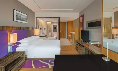 a hotel room with a large bed and a television at Renaissance Bangkok Ratchaprasong Hotel by Marriott in Bangkok