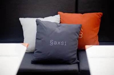 a pile of pillows sitting on top of a couch at Sora Hotel Silom in Bangkok