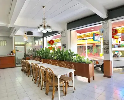 a dining room with a table and chairs at Tat Hotel in Bangkok