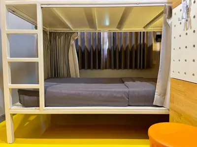a bunk bed room with a bed inside of it at PAMAhouse Boutique Hostel in Bangkok
