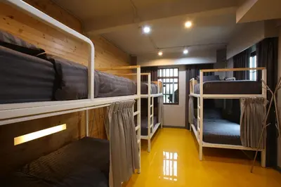 a room with three bunk beds and a hallway at PAMAhouse Boutique Hostel in Bangkok