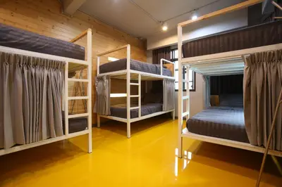 two bunk beds in a room with yellow floors at PAMAhouse Boutique Hostel in Bangkok