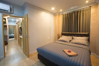 a bedroom with a bed with a towel on it at PAMAhouse Boutique Hostel in Bangkok