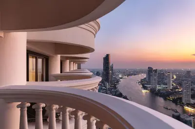 a balcony of a building with a view of a river at Tower Club at lebua in Bangkok