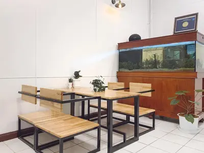 a dining room with a table and chairs and an aquarium at Pillow & Bread Hostel in Bangkok