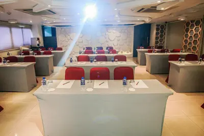 a conference room with tables and chairs and a stage at Northgate Ratchayothin in Bangkok