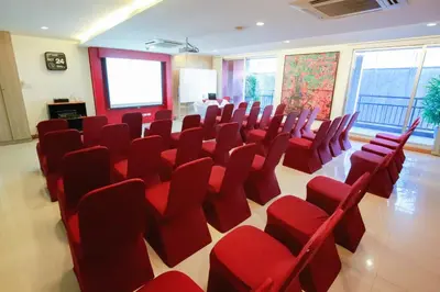 a room with red chairs in a conference room at Northgate Ratchayothin in Bangkok