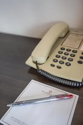 a pen and a phone sitting on a desk at Northgate Ratchayothin in Bangkok
