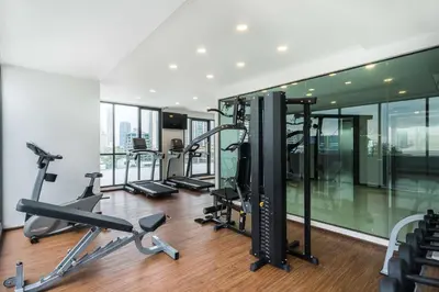 a gym with treadmills and cardio equipment in a building at SureStay Plus by Best Western Sukhumvit 2 in Bangkok