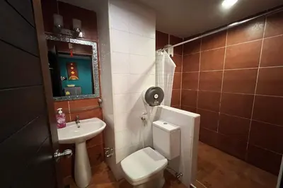 a bathroom with a toilet and a sink at Sabai Sabai@Sukhumvit Hotel in Bangkok