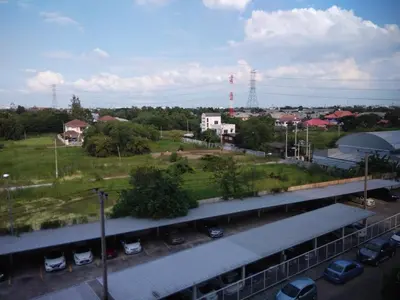 a view of a parking lot with cars parked at Renovate Room Near Impact in Ban Bang Phang