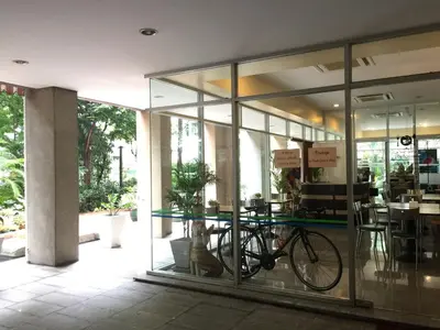 a bike parked inside of a building with glass windows at Rio Monte Residence in Bangkok