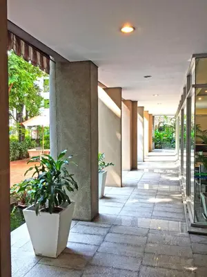 a hallway of a building with potted plants at Rio Monte Residence in Bangkok