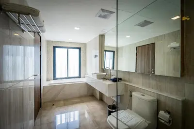 a bathroom with a toilet and a sink and a mirror at Onix Hotel Bangkok in Bangkok