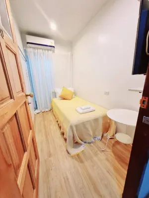 a small room with a bed and a sink at K Home Asok in Bangkok